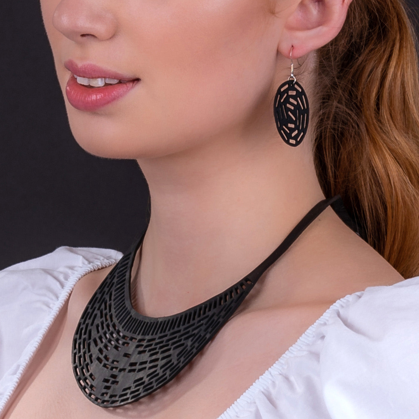 Paguro Upcycle recycled rubber earrings black geometric cutout dangle worn by model for sustainable style