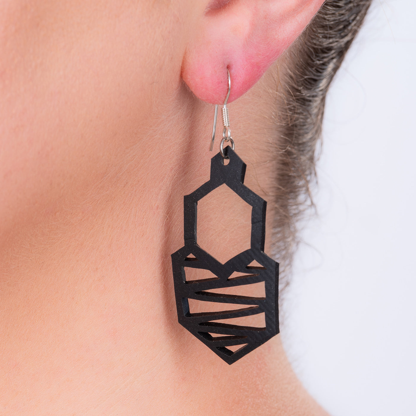 Paguro Upcycle black geometric dangling earring on silver hook made from reclaimed tyre material upcycled rubber earrings