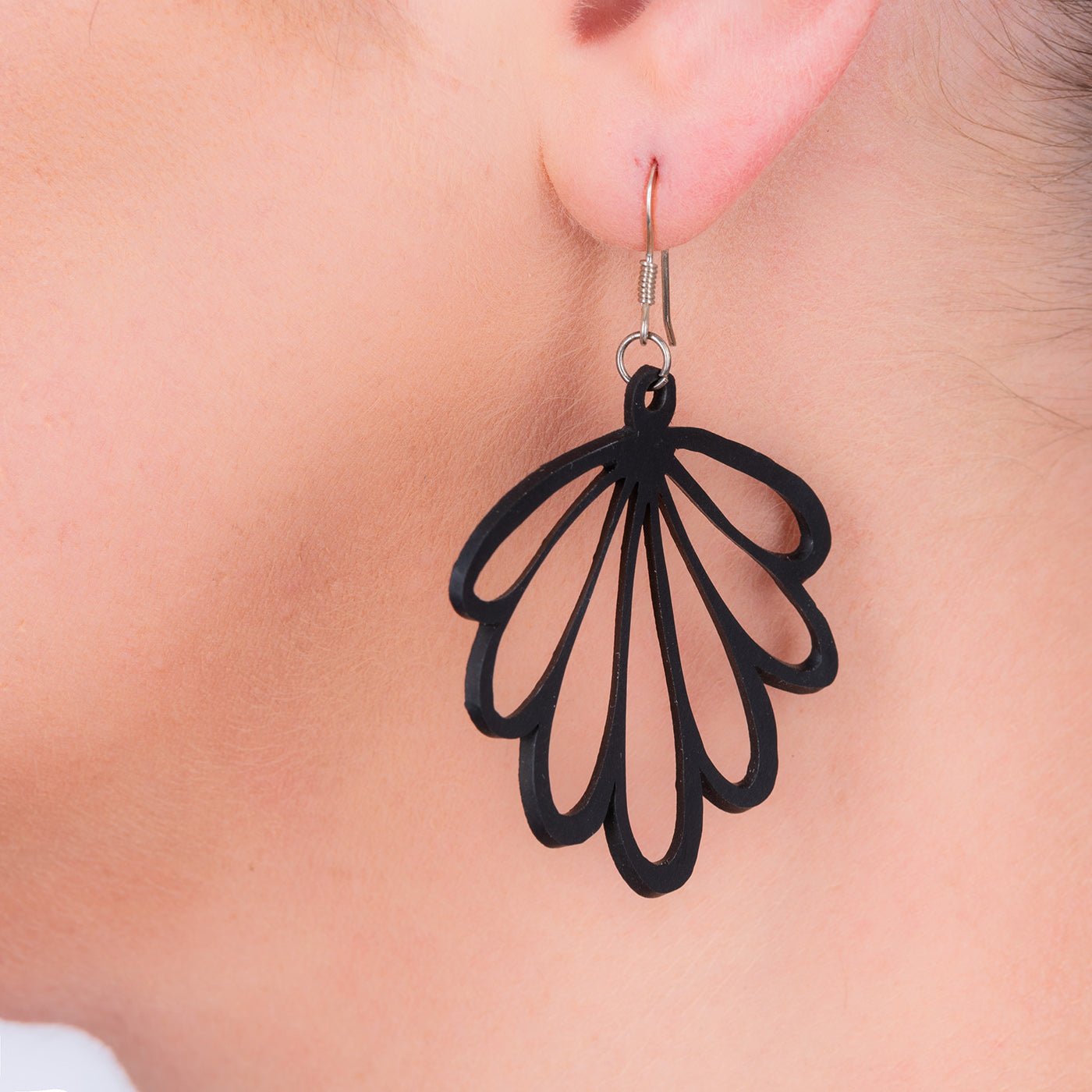 Paguro Upcycle black recycled rubber earrings with unique leaf design worn on ear