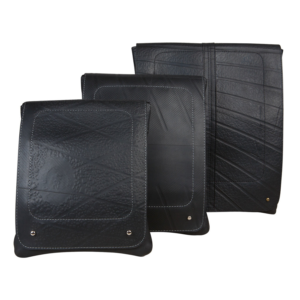 Paguro Upcycle recycled rubber crossbody bag in black with unique textured patterns and adjustable strap
