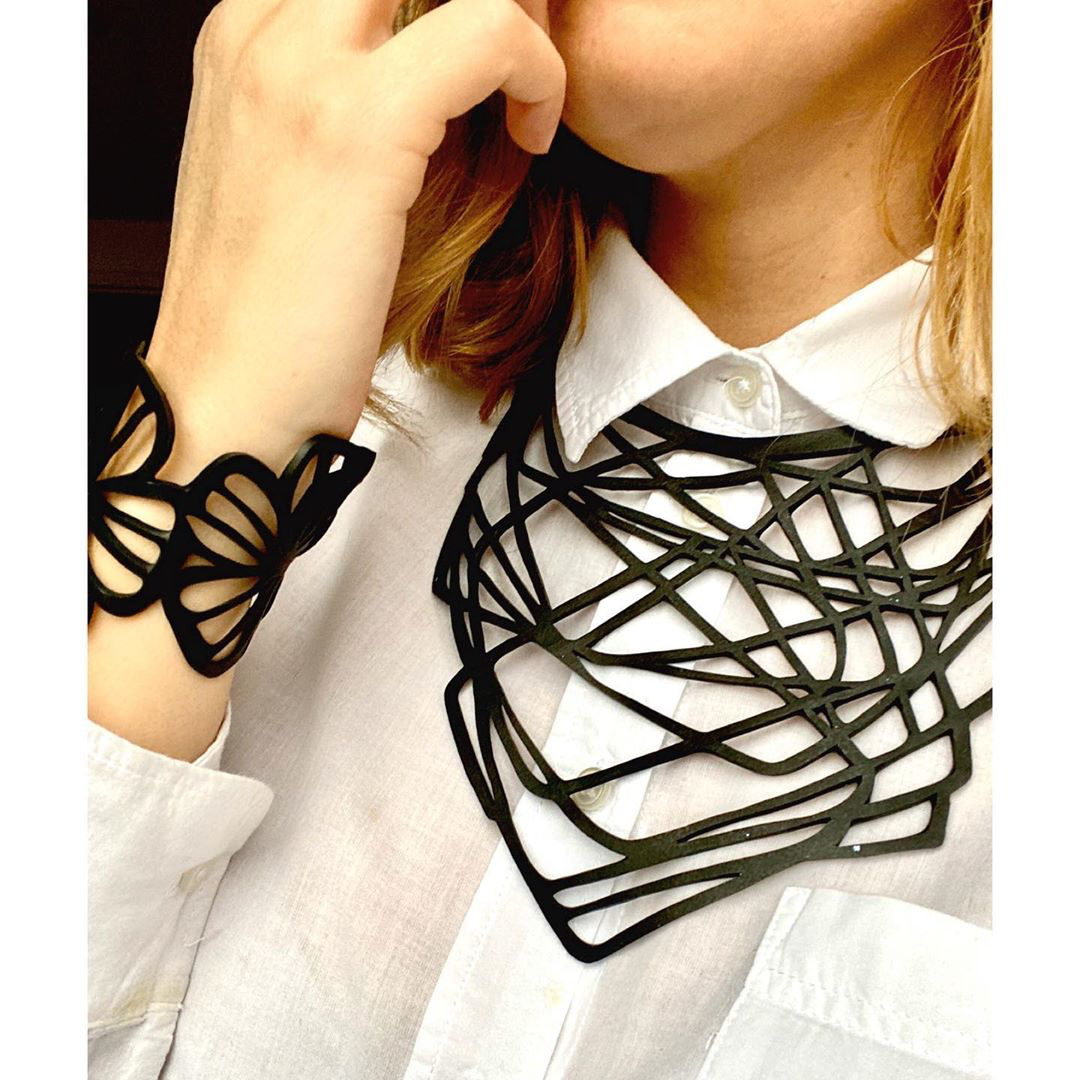 Paguro Upcycle statement upcycled rubber necklace in black geometric design worn with matching bracelet
