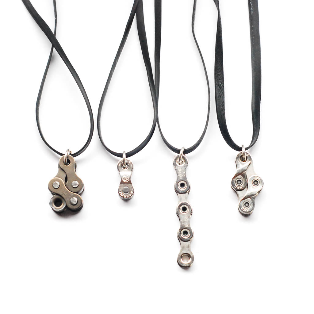 Recycled bike chain pendant necklace collection with various designs on black cords