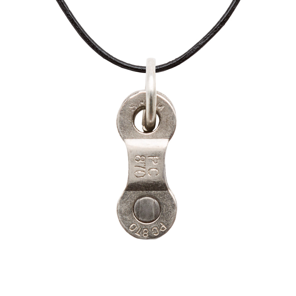 Paguro Upcycle recycled bike chain pendant necklace on a black cord, showcasing a unique design